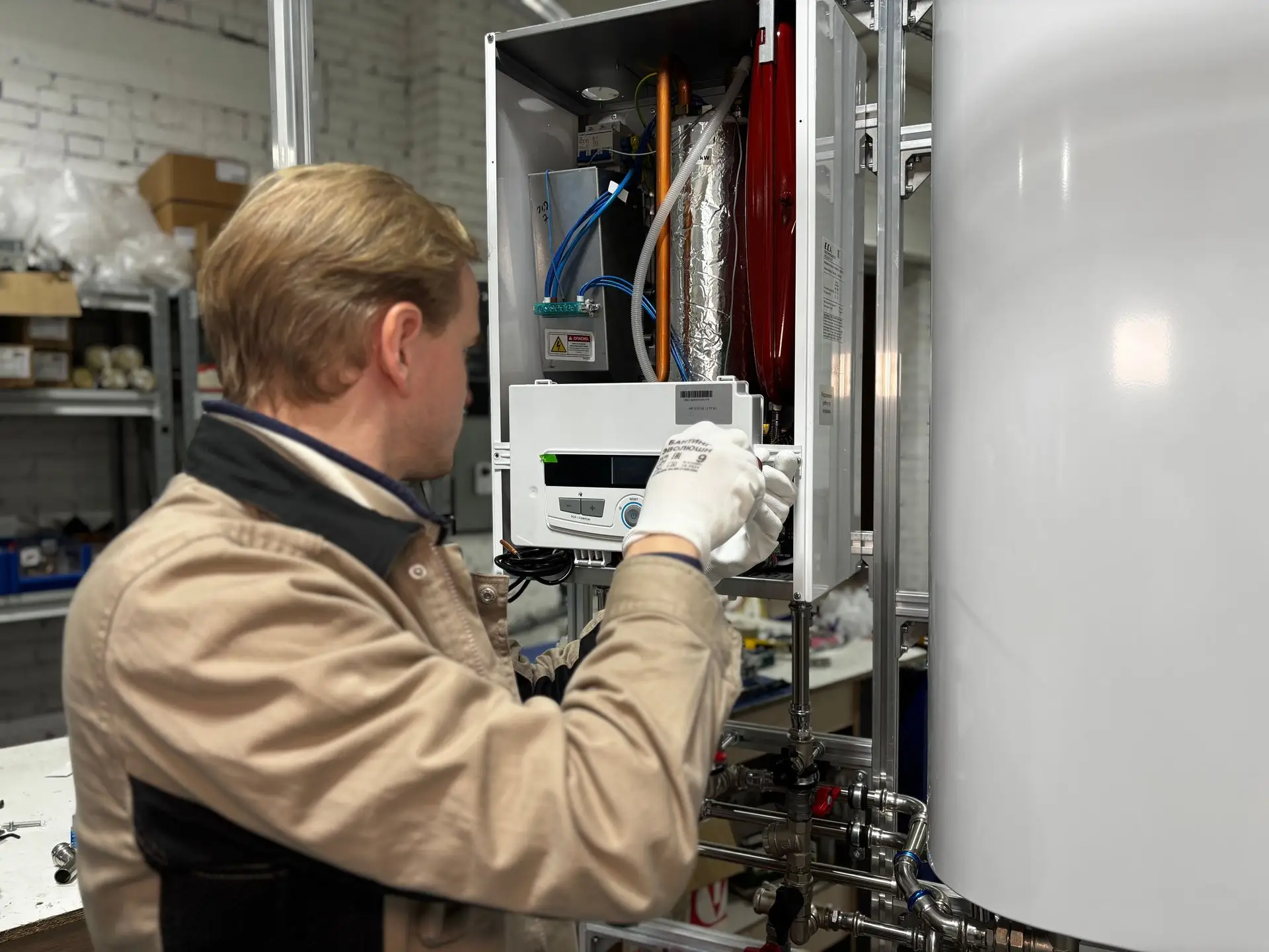 Technician servicing a wall-mounted water heater