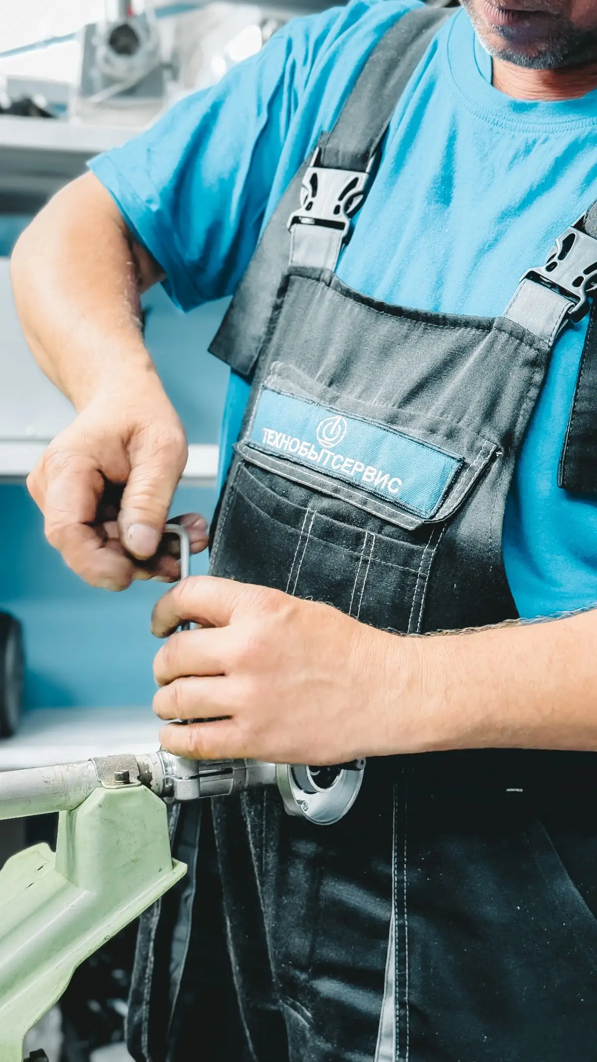 Plumber using a wrench on a pipe fitting