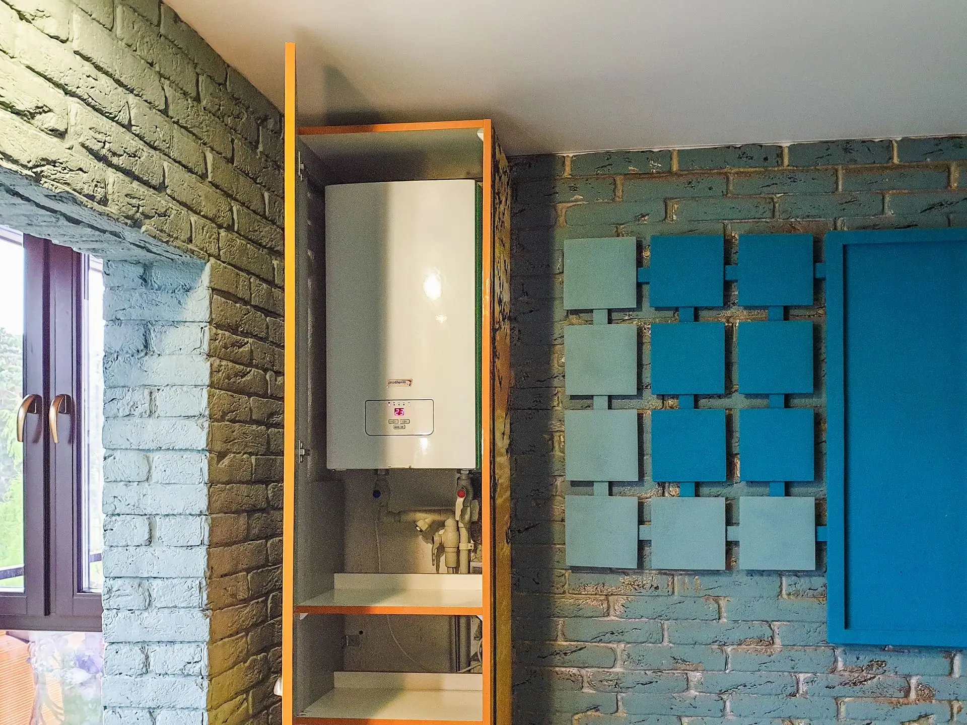Wall-mounted tankless water heater installed in a cabinet